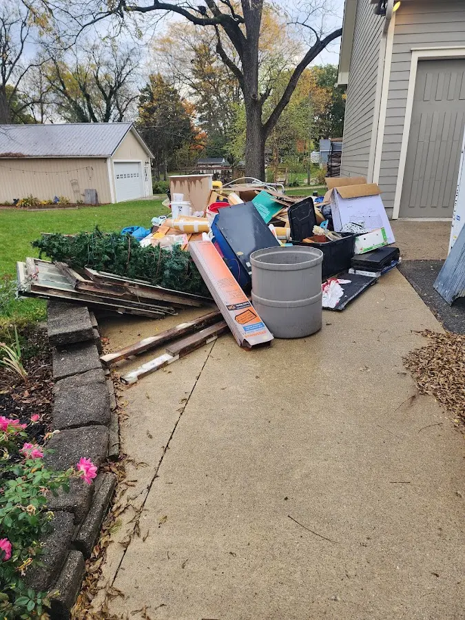 Dumpster being loaded with debris for Estate Cleanout Dumpster Rental in Narragansett